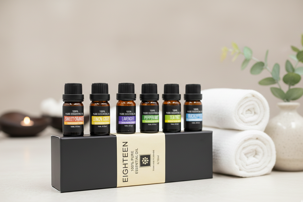 Lura Pure Essential Oils set in a gift box next to white towels and spa stones, highlighting the premium wellness experience.